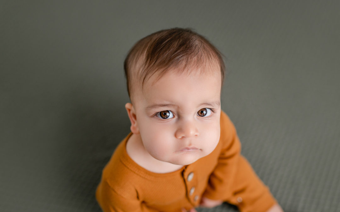 IVF Baby in orange on green backdrop captured by San Diego Photographer