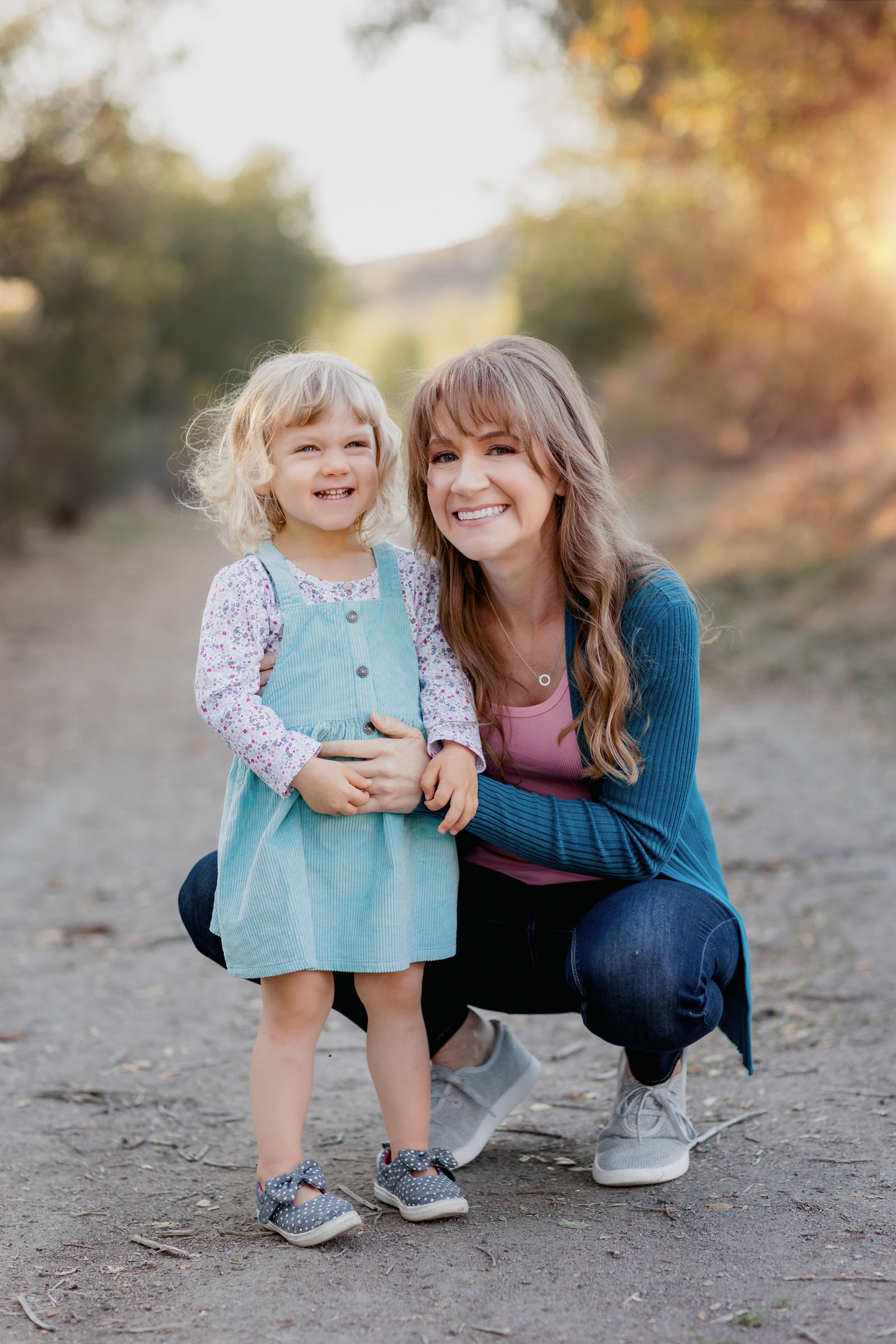 Mom and daughter hugging during outdoor fall family photoshoot in Mission Trails