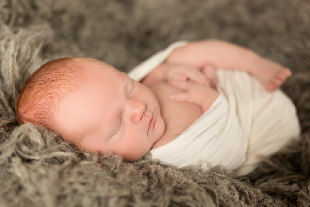 Newborn Posing on Flokati during newborn pictures in San Diego CA