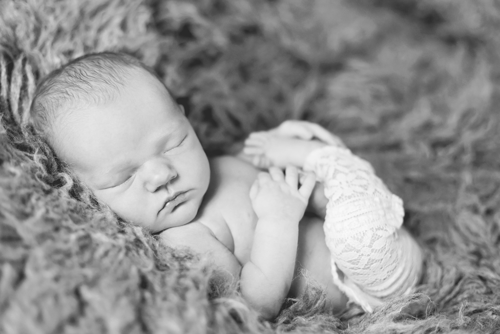 Black and White Flokati posing picture during newborn session in San Diego CA