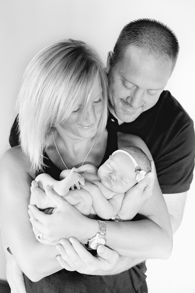 Black and White Parent Posing during Newborn Pictures in San Diego CA