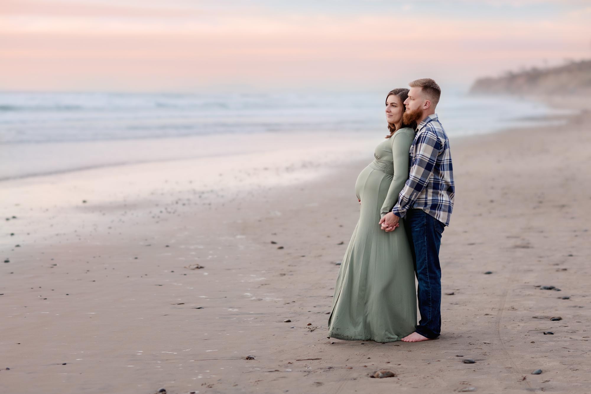 Sunset Maternity Pictures of couple standing on the Torrey Pines Beach at Sunset Seat