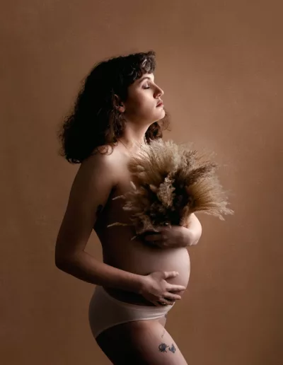 Maternity Portrait of pregnant mom with bare belly and floral covering the chest