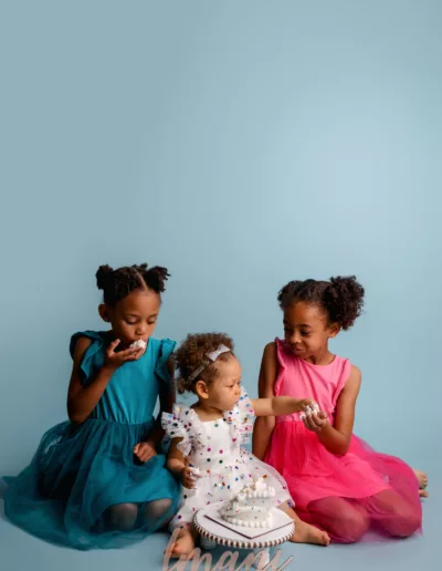 Portrait of three sisters enjoying a cake during a cake smash session in San Diego