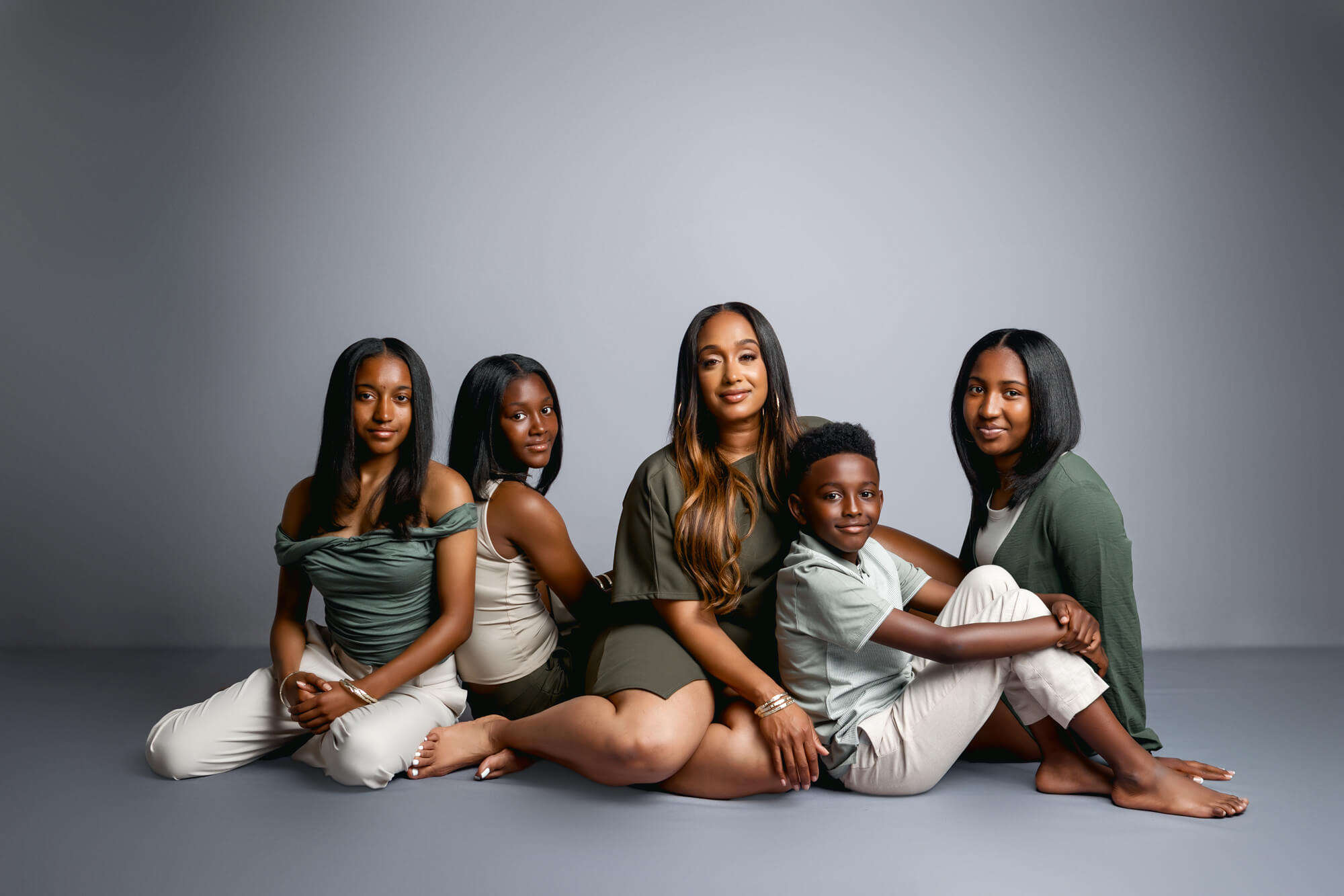 Stunning Studio Portrait of a black family sitting on the floor captured by San Diego Portrait Photographer